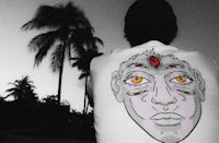 a man wearing a t - shirt with a face on it