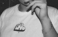 a black and white photo of a woman smoking a cigarette